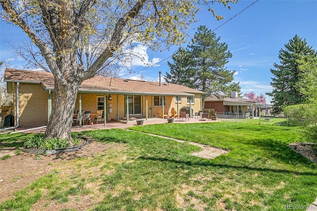 12286 W Tennessee, Lakewood, CO 80228 - back of property with brick siding and a patio