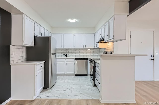 kitchen featuring appliances with stainless steel finishes, backsplash, a textured ceiling, and white cabinetry