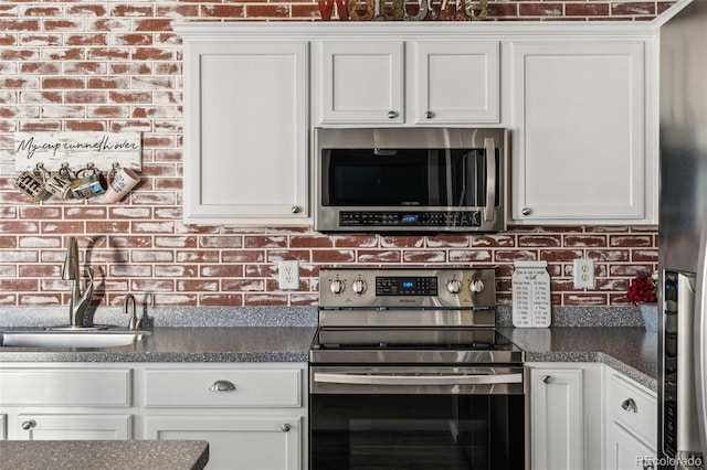 kitchen with sink, white cabinetry, and stainless steel appliances