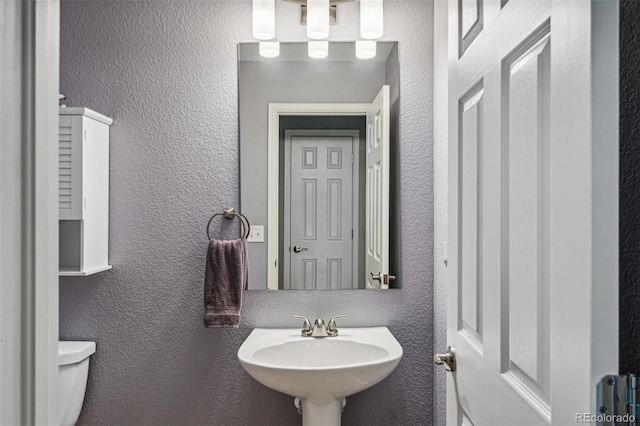 bathroom with sink and toilet