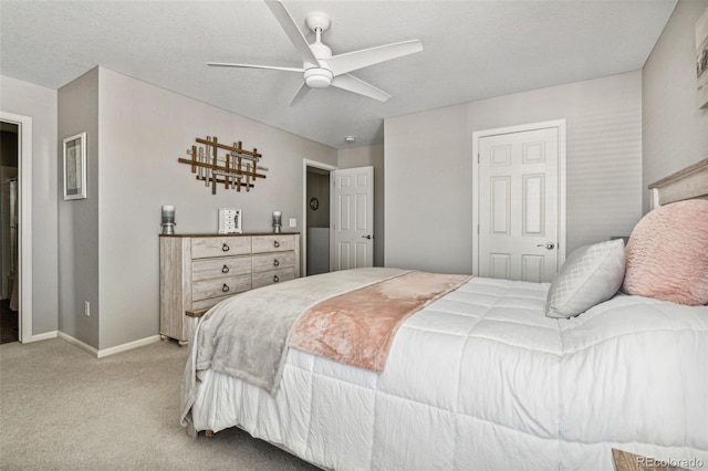 carpeted bedroom featuring ceiling fan and a textured ceiling