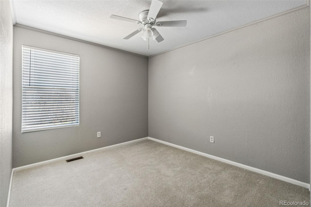 unfurnished room featuring ceiling fan and carpet floors