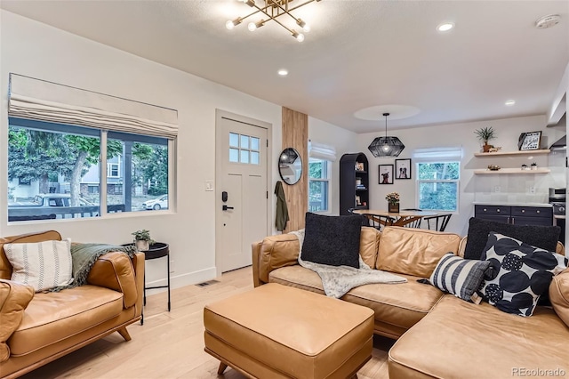 3219 S Washington St, Englewood, CO 80113 - living room with light wood-type flooring, recessed lighting, a chandelier, and arched walkways