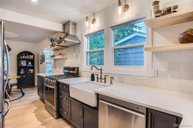 3219 S Washington St, Englewood, CO 80113 - kitchen with open shelves, stainless steel appliances, wall chimney exhaust hood, tasteful backsplash, and light stone countertops