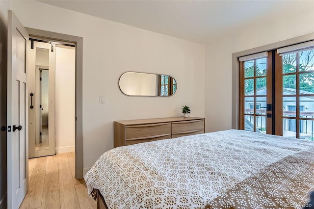 3219 S Washington St, Englewood, CO 80113 - bedroom featuring light wood-type flooring and a barn door