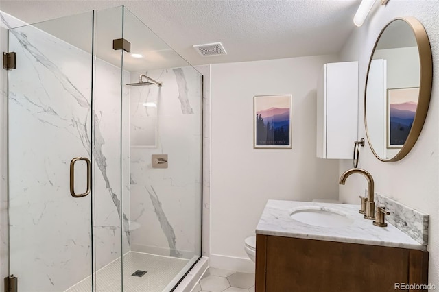 3219 S Washington St, Englewood, CO 80113 - bathroom with vanity, a marble finish shower, a textured ceiling, and tile patterned floors
