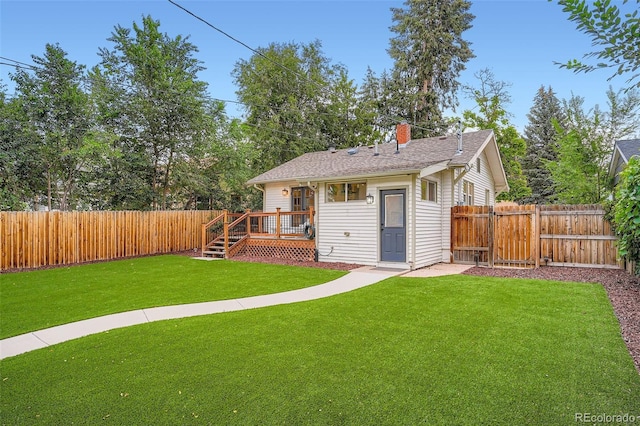 3219 S Washington St, Englewood, CO 80113 - back of house with a fenced backyard, a deck, a chimney, and roof with shingles