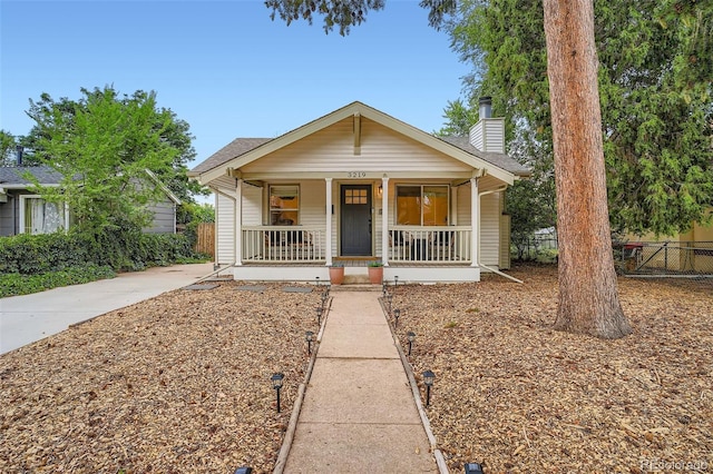 3219 S Washington St, Englewood, CO 80113 - bungalow-style house with a porch, a chimney, and roof with shingles