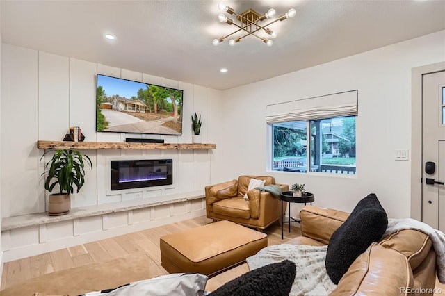 3219 S Washington St, Englewood, CO 80113 - living area featuring wood finished floors, a chandelier, recessed lighting, and a glass covered fireplace