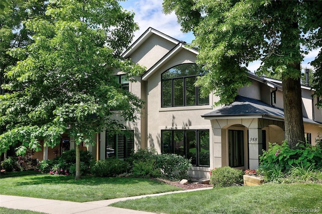 355 Steele St, Denver, CO 80206 - view of front of house featuring stucco siding and a front yard