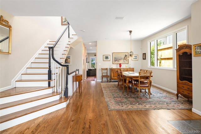 355 Steele St, Denver, CO 80206 - dining room featuring wood finished floors, stairway, healthy amount of natural light, baseboards, and recessed lighting