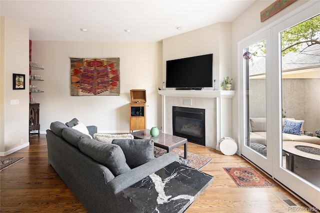 355 Steele St, Denver, CO 80206 - living area with a tile fireplace, wood finished floors, and recessed lighting
