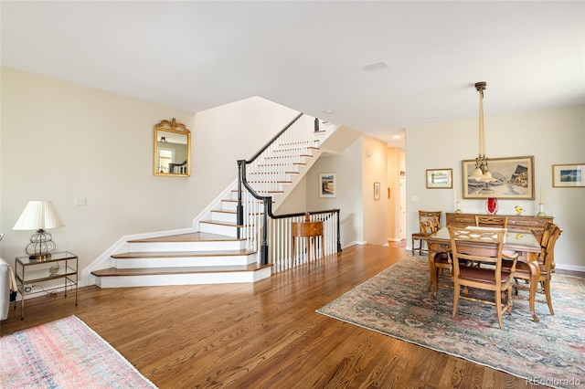 355 Steele St, Denver, CO 80206 - dining room with wood finished floors, baseboards, and stairs