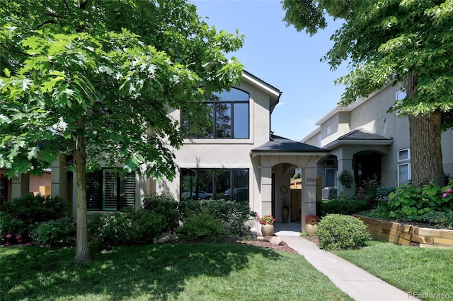 355 Steele St, Denver, CO 80206 - view of front of property with stucco siding and a front lawn