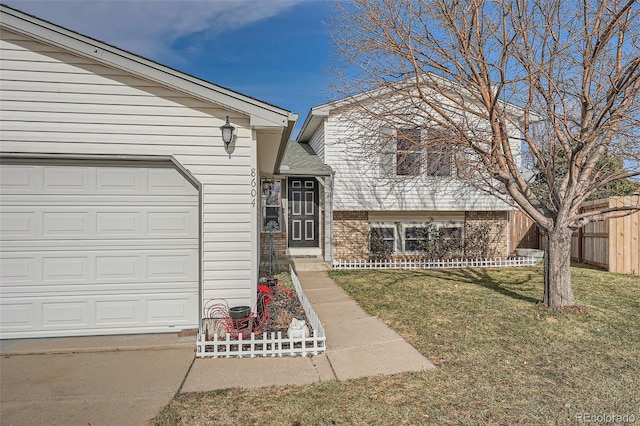 entrance to property with a yard and a garage