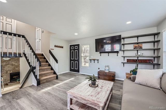 living room with a fireplace and hardwood / wood-style flooring