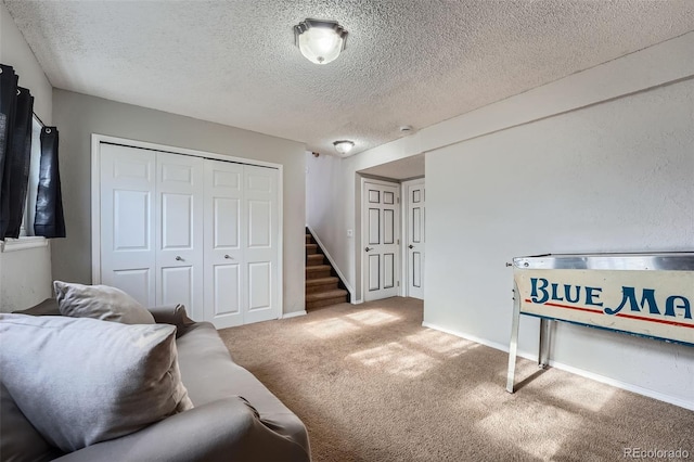 carpeted living room with a textured ceiling