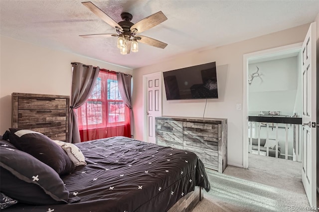 bedroom featuring ceiling fan, carpet floors, and a textured ceiling