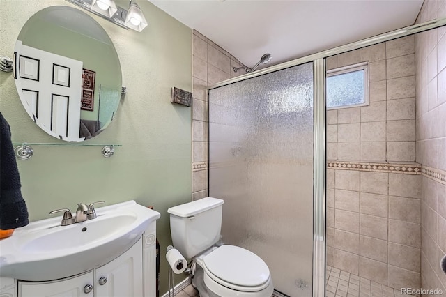 bathroom featuring vanity, an enclosed shower, and toilet