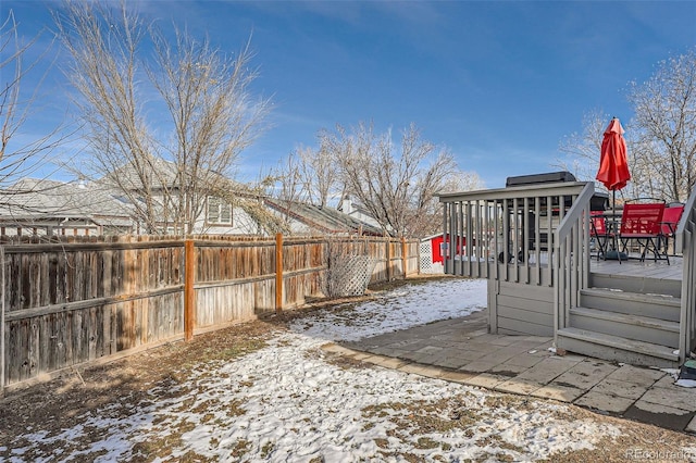 yard layered in snow featuring a wooden deck