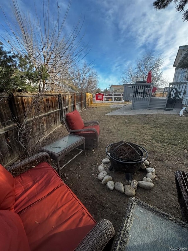 view of yard featuring a fire pit, a patio area, and a deck