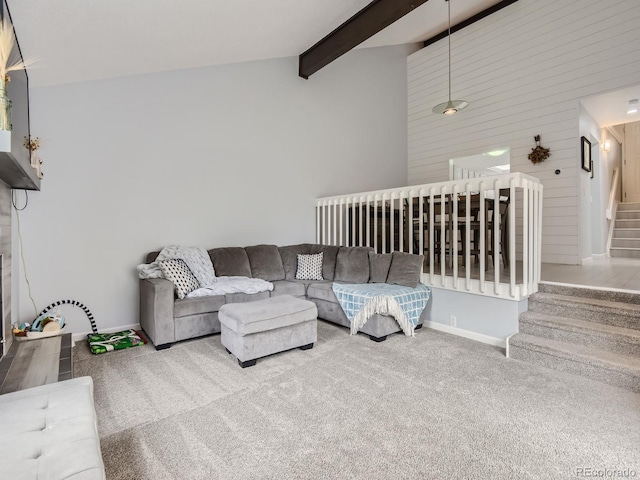 carpeted living room with high vaulted ceiling and beam ceiling