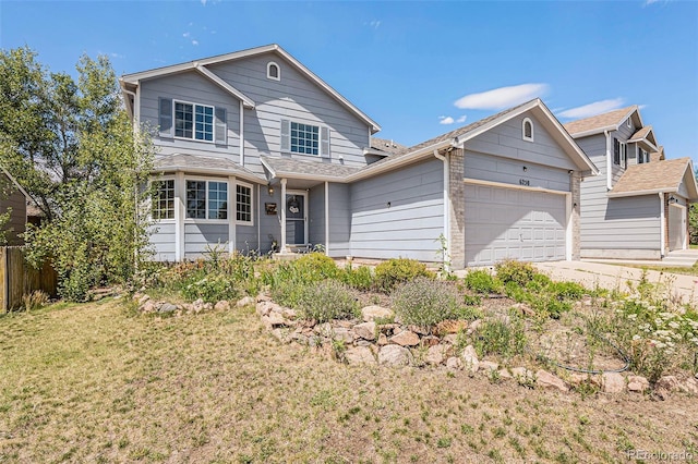 front of property with a garage and a front lawn