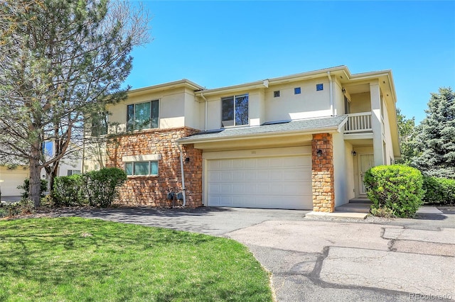 multi unit property featuring a garage and a balcony