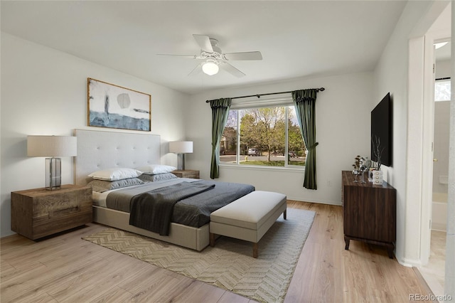 bedroom with ceiling fan, light hardwood / wood-style floors, and ensuite bath