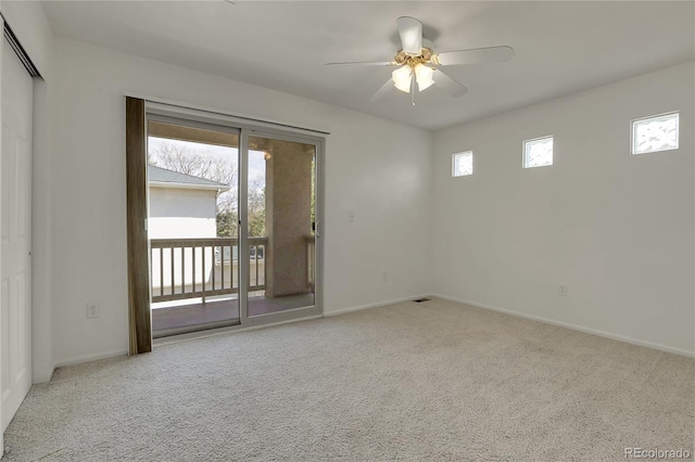 empty room with ceiling fan and light colored carpet