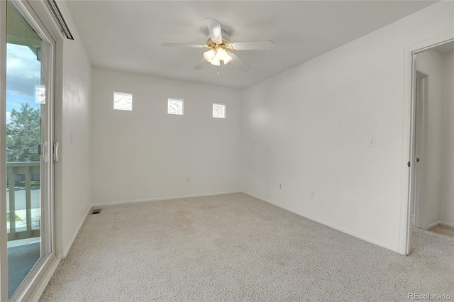 spare room featuring ceiling fan and light carpet