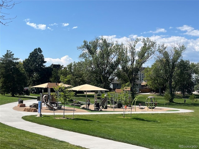 view of property's community with a playground and a lawn