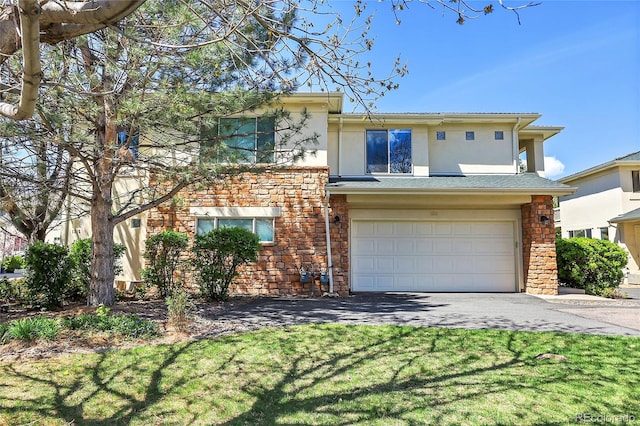 view of front of property with a front yard and a garage