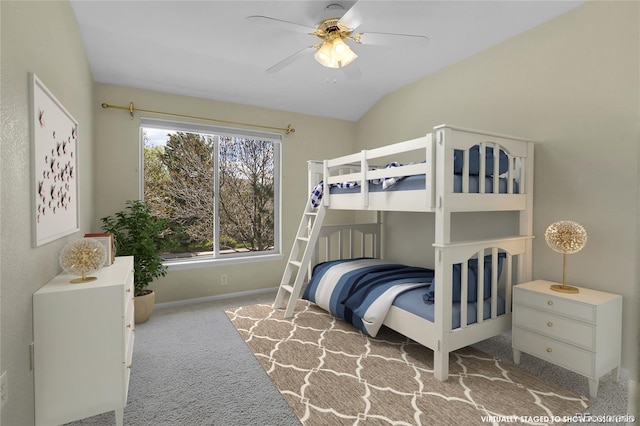 bedroom with ceiling fan, light colored carpet, and vaulted ceiling