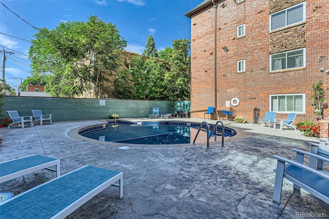 view of swimming pool with a patio