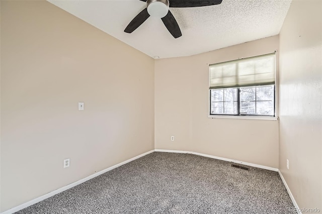 carpeted spare room with visible vents, baseboards, a textured ceiling, and ceiling fan