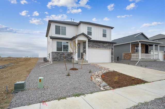 13467 Valentia St, Thornton, CO 80602 - view of front facade featuring stone siding, driveway, board and batten siding, and a garage