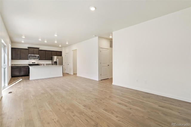 13467 Valentia St, Thornton, CO 80602 - unfurnished living room featuring recessed lighting and light wood-style floors