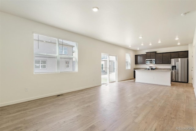 13467 Valentia St, Thornton, CO 80602 - unfurnished living room with light wood-type flooring and recessed lighting