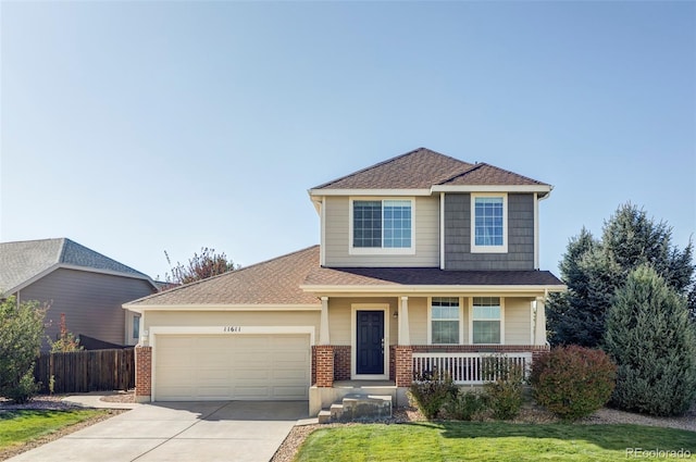 view of front of house with a front yard, a porch, and a garage