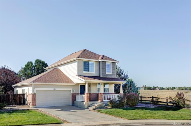 front facade featuring a porch, a garage, and a front lawn