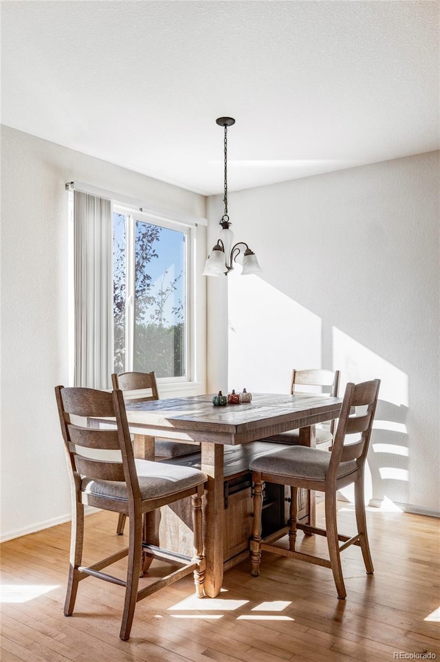 dining room with an inviting chandelier and light wood-type flooring