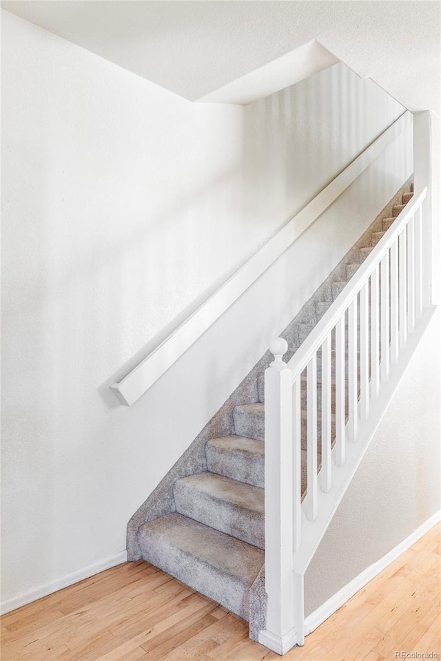 stairs featuring wood-type flooring