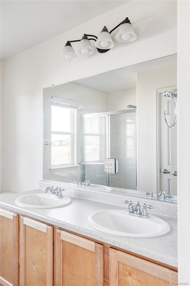 bathroom with an enclosed shower and vanity