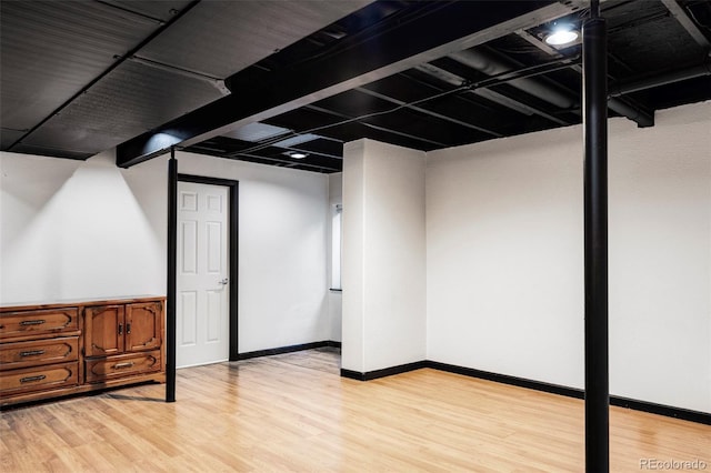 basement with light hardwood / wood-style flooring