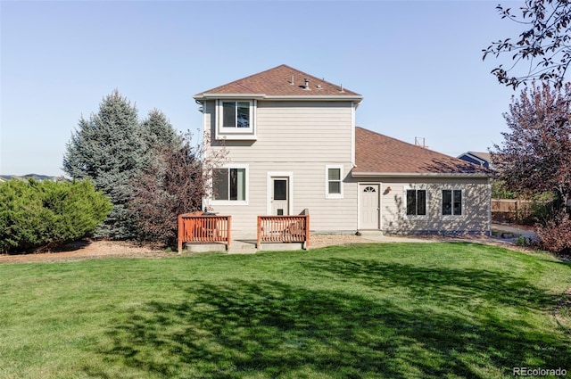 back of house featuring a yard and a deck