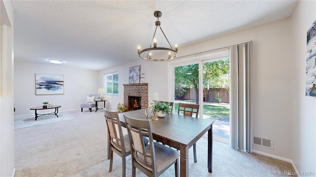1820 W 104th Pl, Northglenn, CO 80234 - dining space featuring light carpet, a brick fireplace, a textured ceiling, and a chandelier