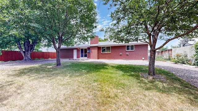1820 W 104th Pl, Northglenn, CO 80234 - back of property featuring a chimney and brick siding