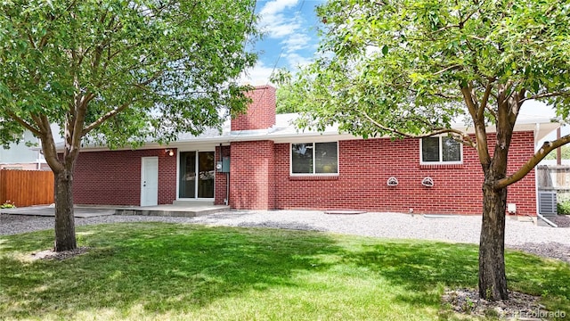 1820 W 104th Pl, Northglenn, CO 80234 - back of property with a chimney, brick siding, and a patio area