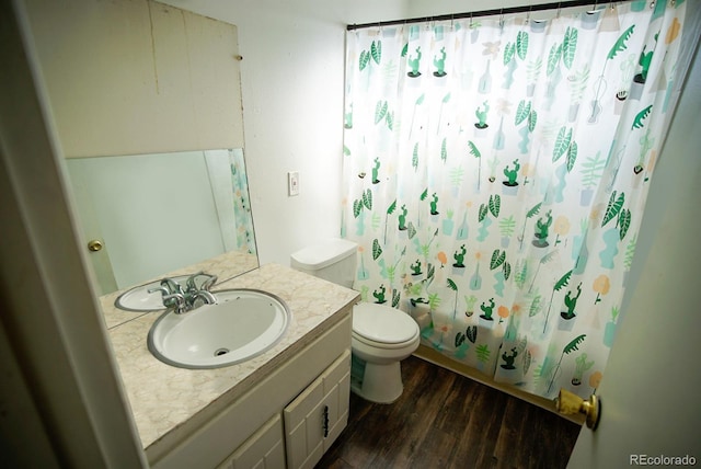 full bath featuring vanity, shower / bath combo, wood finished floors, and toilet